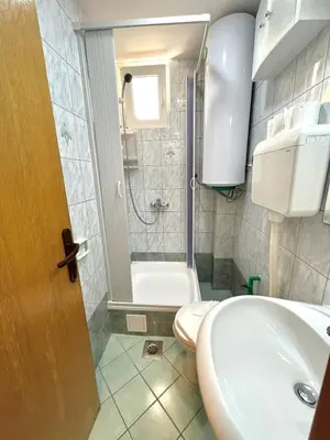 a bathroom with a sink and a toilet and a shower at Apartments Sofija in Budva