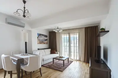 a living room with a white couch and a table at Apartments LORA Jadranskij put in Budva