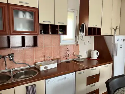 a small kitchen with a sink and a refrigerator at Apartment Helena Airport in Podgorica