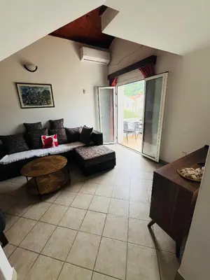 a living room with a couch and a table at Apartment Dijana in Petrovac na Moru