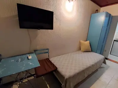 a small room with a bed and a flat screen tv at Vojinovic Apartments in Budva