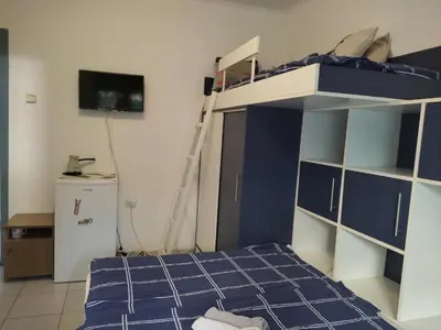 a bedroom with a bunk bed and a tv at Vojinovic Apartments in Budva
