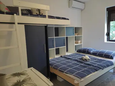 a bedroom with a bunk bed with a blue mattress at Vojinovic Apartments in Budva