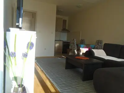 a living room with a couch and a coffee table at Fantastic brand new apartment in Podgorica