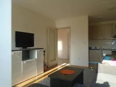 a living room with a flat screen tv and a couch at Fantastic brand new apartment in Podgorica