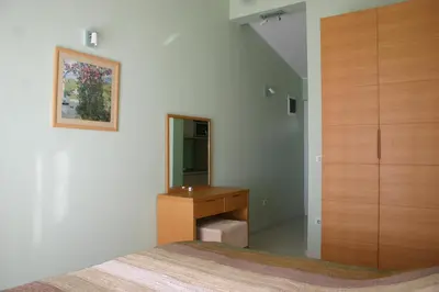 a bedroom with a sink and a mirror at Apartments & Rooms Elite in Dobra Voda