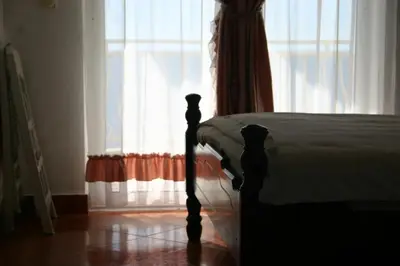 a bedroom with a bed in front of a window at Apartments & Rooms Elite in Dobra Voda