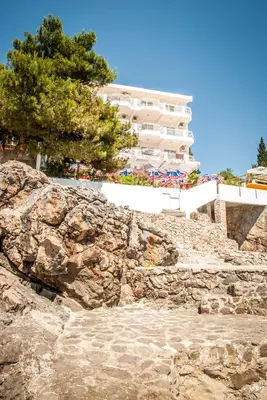 a stone staircase leading up to a large building at Apartments & Rooms Elite in Dobra Voda