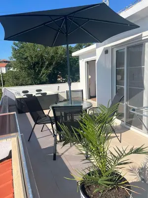a patio with a table and chairs and an umbrella at Demiri Rr in Ulcinj