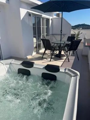 a swimming pool with a table and an umbrella at Demiri Rr in Ulcinj