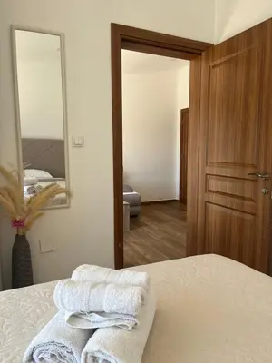 a bedroom with two towels on a bed and a mirror at Demiri Rr in Ulcinj