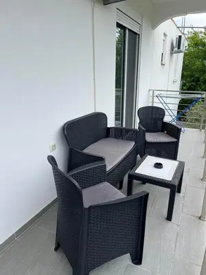 a patio with wicker chairs and a table at Demiri Rr in Ulcinj