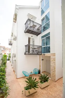 a building with two chairs and a balcony at Villa DiEden in Budva