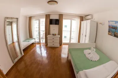 a bedroom with a bed and a dresser and a mirror at Villa DiEden in Budva