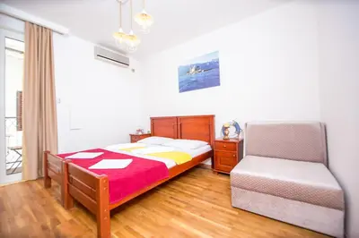 a bedroom with a bed and a chair at Villa DiEden in Budva