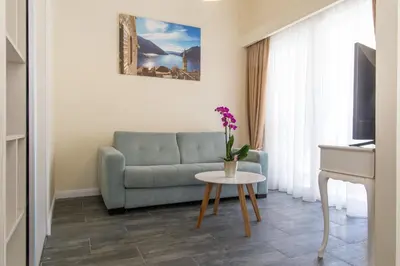 a living room with a couch and a table at Villa DiEden in Budva