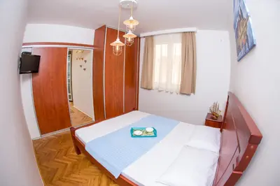 a small bedroom with a bed with a tray on it at Villa DiEden in Budva
