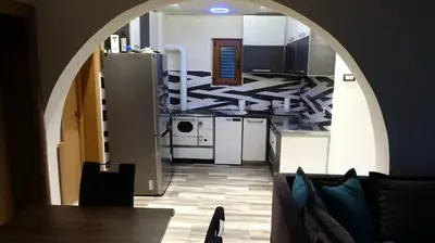 a kitchen with an archway leading into a room at Apartment Kraljica Jelena in Virpazar