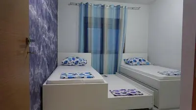 a small room with two beds and a curtain at Apartment Kraljica Jelena in Virpazar