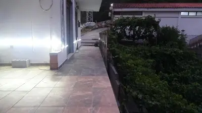 a porch of a house with a fence and plants at Apartment Kraljica Jelena in Virpazar