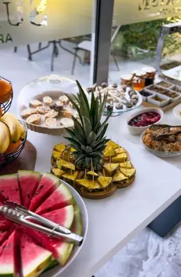 a table with many different types of food on it at Sunrise Apart-Hotel in Ulcinj