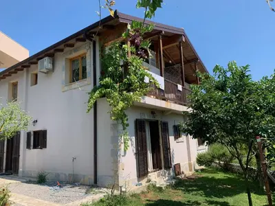 an old house with a balcony and trees at Accommodation 
