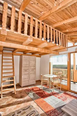 a living room with a loft bed and a table at Accommodation 