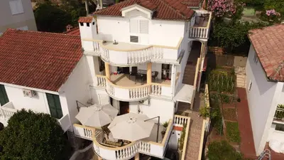an overhead view of a white house with umbrellas at Villa Vojnic in Budva