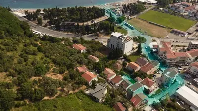an aerial view of a city with houses and the ocean at Villa Vojnic in Budva