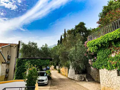 a street with cars parked on the side of the road at Villa Vojnic in Budva