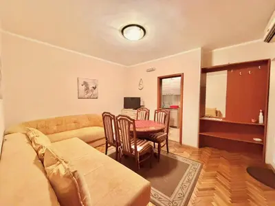 a living room with a couch and a table at Beachfront Apartments Oaza 1 in Petrovac na Moru