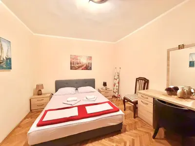a bedroom with a bed and a desk in it at Beachfront Apartments Oaza 1 in Petrovac na Moru