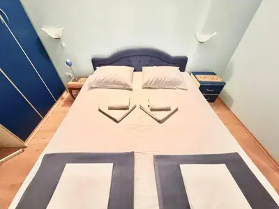 a bedroom with a bed with two pillows on it at Beachfront Apartments Oaza 1 in Petrovac na Moru