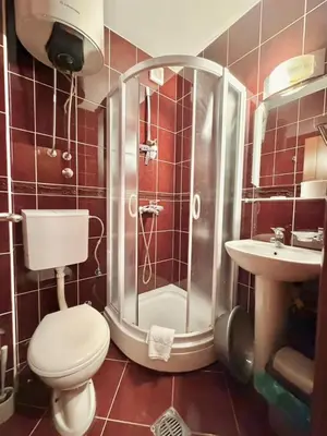 a bathroom with a shower and a toilet and a sink at Beachfront Apartments Oaza 1 in Petrovac na Moru