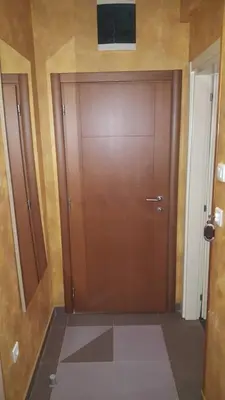a large wooden door with a television on top of it at Apartman Centar Lux in Budva
