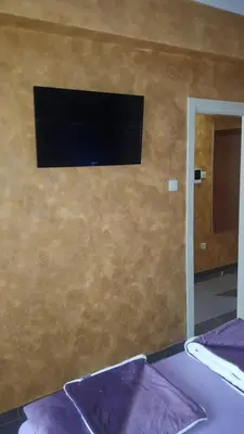 a flat screen tv on the wall of a bedroom at Apartman Centar Lux in Budva