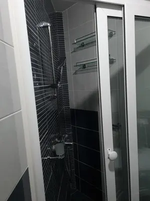 a bathroom with a shower with a glass door at Apartman Centar Lux in Budva