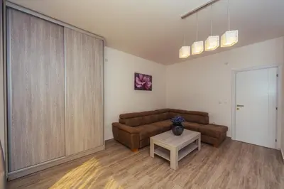 a living room with a couch and a table at Apartments Monte Re in Petrovac na Moru