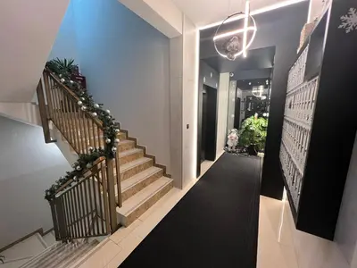 a staircase in a house with a black and white hallway at Fanky City Apartments in Podgorica