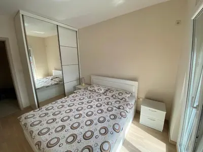 a bedroom with a bed and a large mirror at Fanky City Apartments in Podgorica