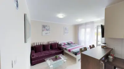 a living room with a purple couch and a table at Adagio apartment in Cetinje