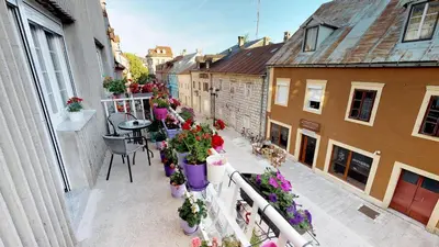 an apartment balcony with potted plants and a table at Adagio apartment in Cetinje