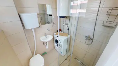a bathroom with a shower and a toilet and a sink at Adagio apartment in Cetinje