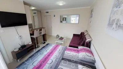 a small room with a bed and a couch at Adagio apartment in Cetinje