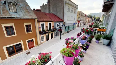 a street filled with lots of pots of flowers at Adagio apartment in Cetinje