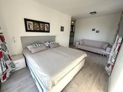 a bedroom with a large bed and a couch at Villa Mona 2 in Budva