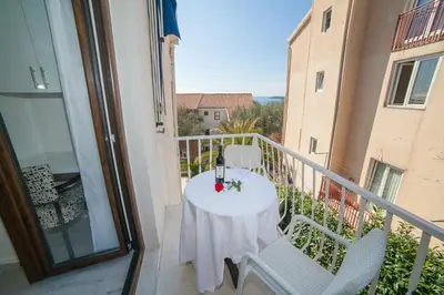 a balcony with a table and chairs on a balcony at Villa Mona 2 in Budva