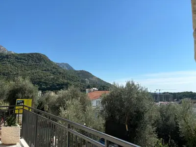 a balcony with trees and mountains in the background at Villa Mona 2 in Budva