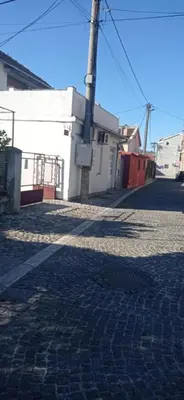 a cobblestone street in front of a white building at Sweet Dream Rooms in Podgorica