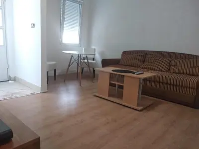 a living room with a couch and a table at Sweet Dream Rooms in Podgorica